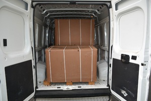 Krajanka tytoniowa znajdowała się w 9 pudłach biały bus ma otwarte tylne drzwi a wewnątrz stoi pudło z zatrzymanym tytoniem